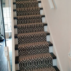 Stair runner on hardwood stairs, available at Direct Flooring Deals.
