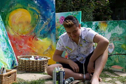 Artist Aiden Lee sitting on the ground