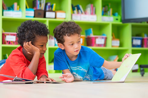 children reading books on the floor