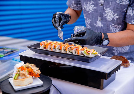 One of our Talented chefs is preparing sushi rolls from fresh ingredients and present it in a plate