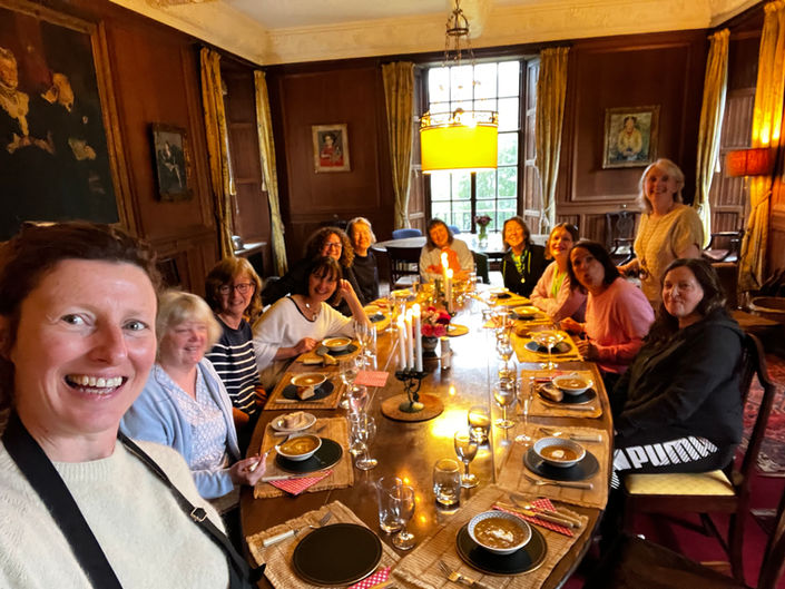 Group photo, smiling faces, a large table in a dining room on a retreat in Scotland with Fiona Marshall Yoga