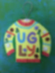 A bright yellow and red ugly Christmas sweater is painted onto a green background. A small piece of elastic string is glued to the neck hole to appear like an ornament.