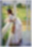 Oil on canvas painting of a girl in a white saree and blouse standing at a white painted balcony looking out at the fields.