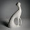 Thumbnail: A porcelain white cat is depicted in a sitting position, with its tail wrapped around its body. Back view