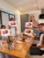 Students holding KitKat paintings in mindful art classes
