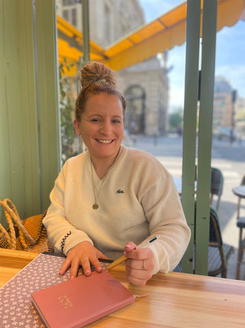 French tutor and student at a Parisian café terrace — combining language learning with local culture