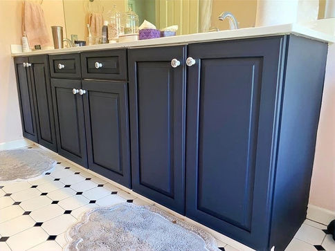 After image of bathroom vanity painted a deep blue and refinished with new ceramic hardware.