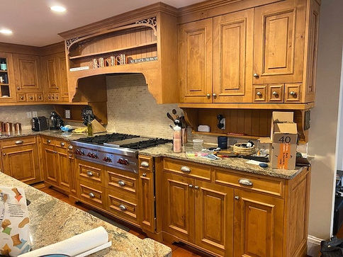 Before picture of unfinished kitchen with wood finish prior to painting. 