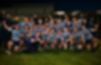 Team of young men rugby players in blue/white stripes celebrate holding a trophy after winning the Metropolitan Cup