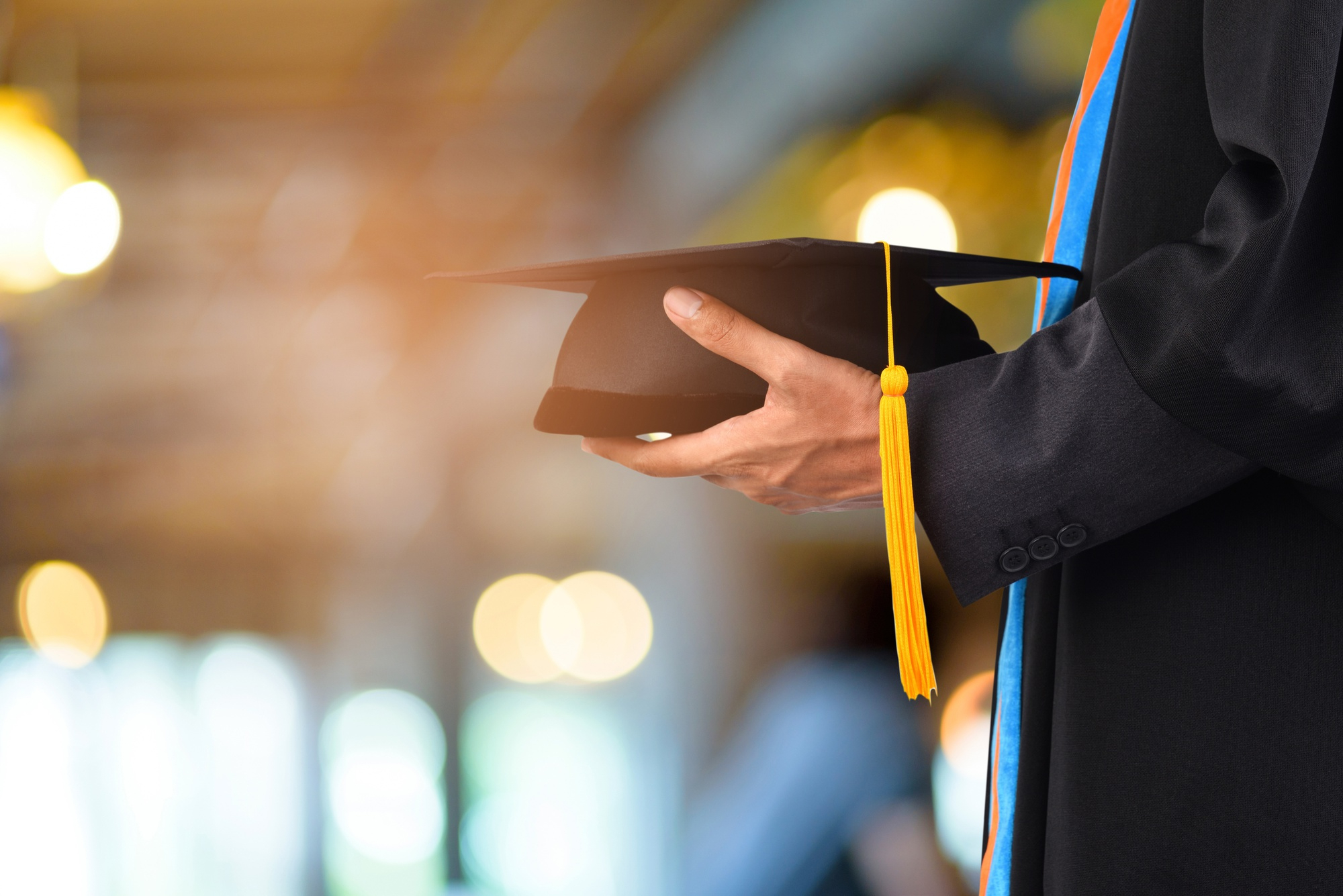 graduation-take-black-yellow-tassel-front-bokeh-blurry-background.jpg
