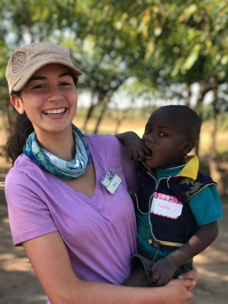 Anna holding child in Malawi.
