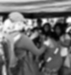 Micaela on the left praying over a woman.