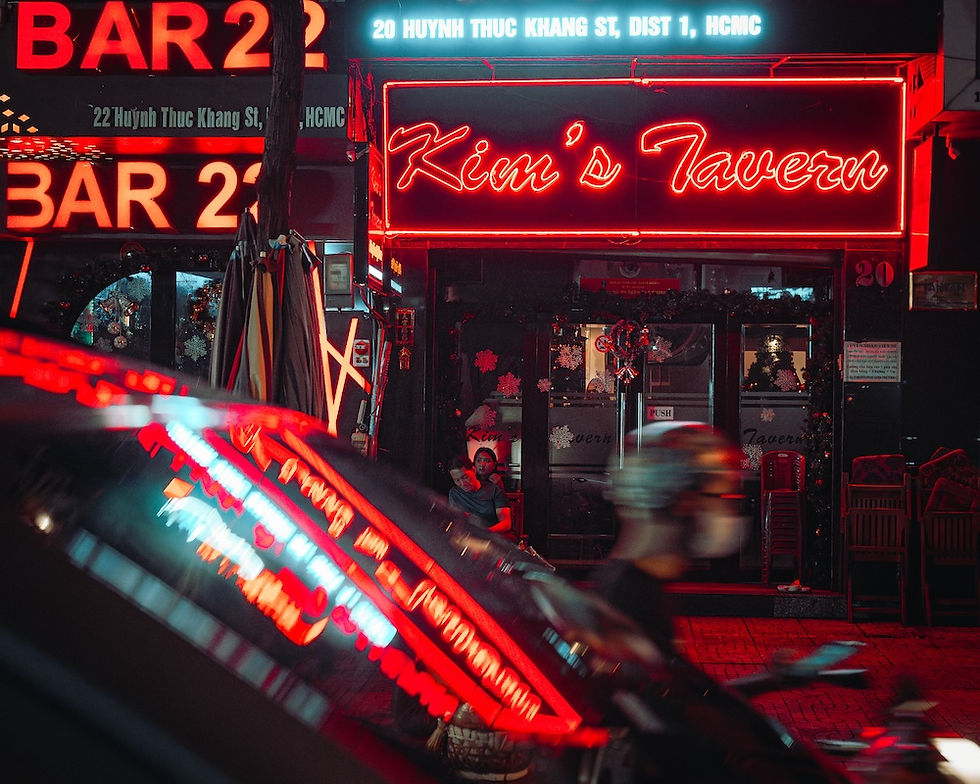 Thumbnail: A neon-lit street at night, with a bright sign displaying “Klaus’s Tavern” and a blurred figure passing by.