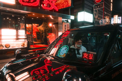 A taxi driver stops on a neon-lit street in Kabukicho, Tokyo, capturing the vibrant nightlife in a City Nights street photography shot by Deniz Demir.







