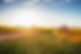 Tractor on dirt road amidst field during sunset