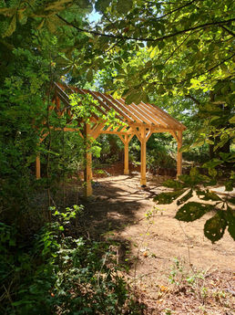 Gable roofed gazebo in the forest