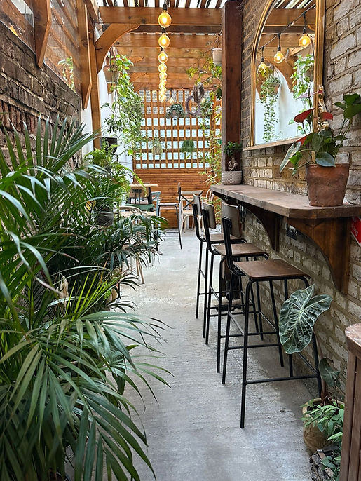 Mabelle's Café Interior with Bar Stools and Plants