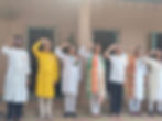 Group saluting in traditional Indian attire at a gallery event.