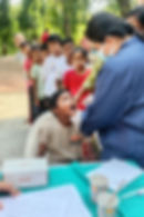 Health worker performing a dental checkup on a child