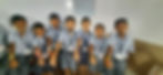 Schoolboys in uniform showing handmade bracelets.