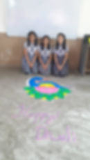 Students with peacock rangoli and Happy Diwali message