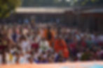 Large crowd gathered for an outdoor assembly in a courtyard