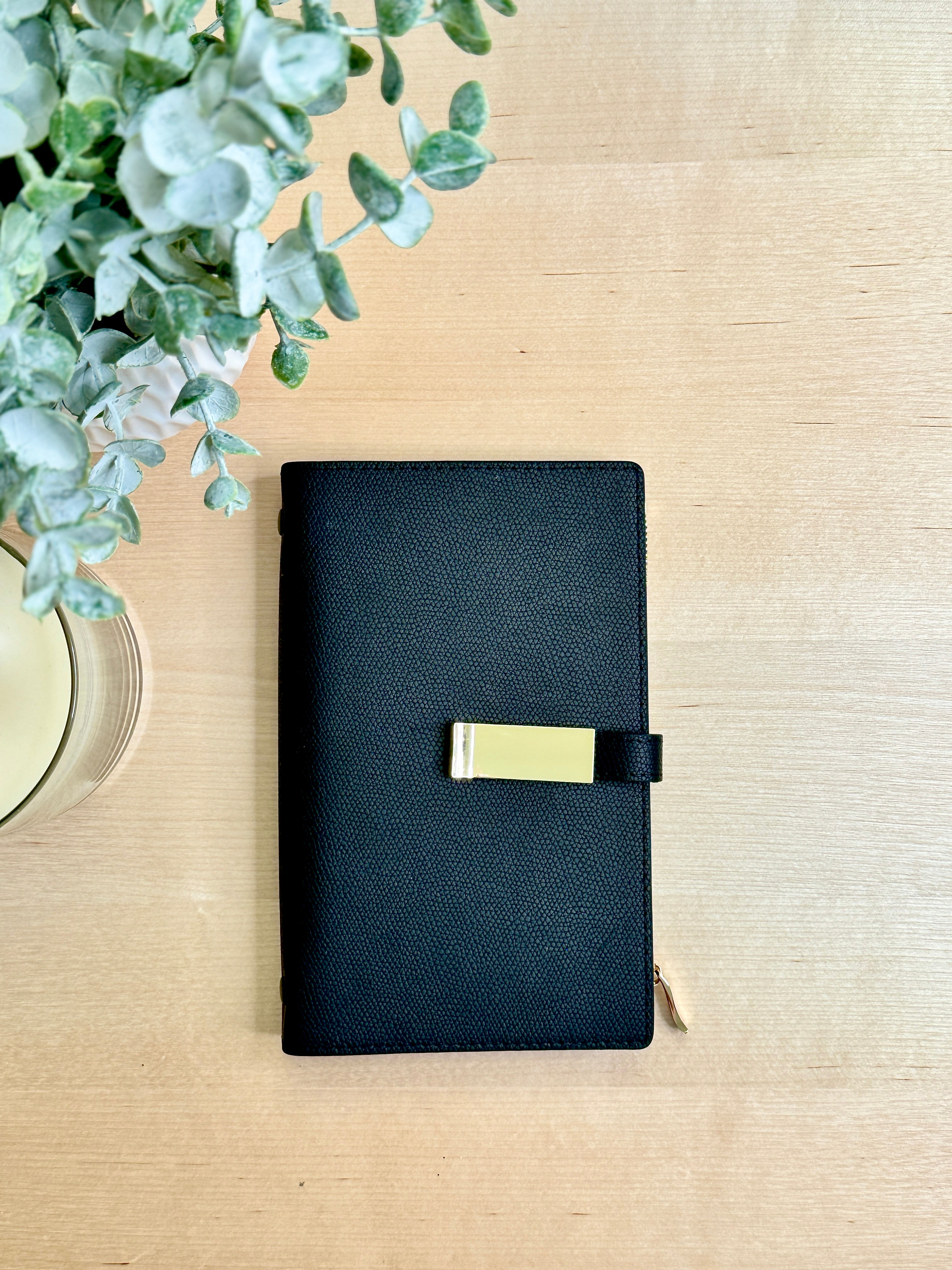 Black A6 Wallet. Buckle Close and Inner Zipper.