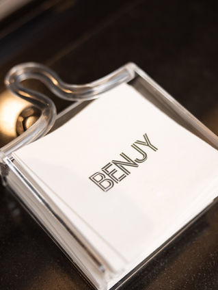 Personalized Benjy napkins in an acrylic holder at a bar mitzvah