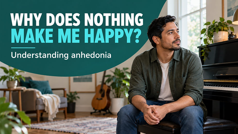 Man sits on a bench in a living room beside a piano, looking off to the side; overlay text reads, “WHY DOES NOTHING MAKE ME HAPPY? Understanding anhedonia.”
