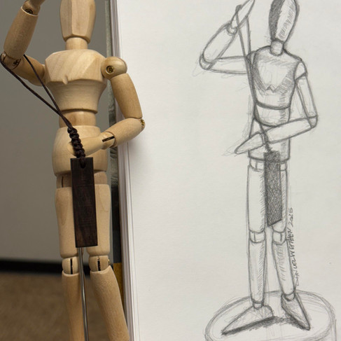 A pencil sketch of a miniature wooden mannequin next to a posed wooden mannequin