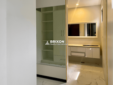 Vanity area with built-in shelves and mirror cabinet