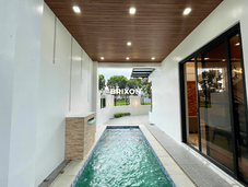 Narrow lap-style dipping pool with modern tiled flooring