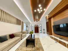 Open layout living and dining space with marble flooring