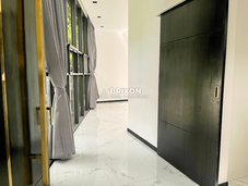 Walk-in closet hallway with built-in storage and modern lighting