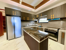 Contemporary kitchen with island counter and built-in cabinets