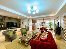 Luxury dining room with chandelier and designer seating.
