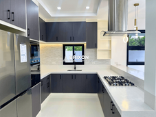Elegant kitchen with built-in refrigerator, oven, and white countertop.