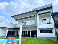 Rear view of the modern two-storey house with pool and balcony.