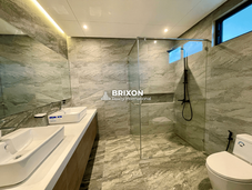 Luxurious bathroom with gray marble tiles and dual sinks.