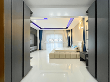 View of the master suite hallway connecting two modern bedrooms.