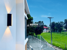 Exterior wall detail with black modern wall lamp and clean white finish