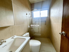 Bathroom with double sink and mirror, beige tile design