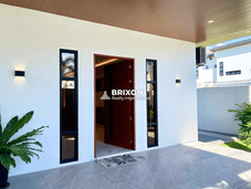 Covered main entrance with modern wooden door design