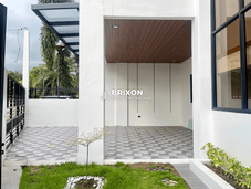 Covered walkway leading to the main door with landscaped side garden