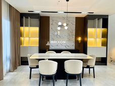 Luxury dining area with built-in warm lighting and wall accents