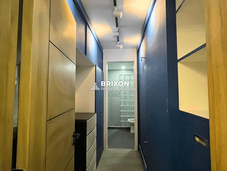 Walk-in closet with built-in wooden wardrobes and modern design.