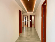 Hallway with recessed lighting and polished wooden doors