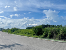 Wide roadside view of the 7.3-hectare land in San Fernando, Pampanga with clear skies