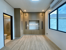 Bedroom with floor-to-ceiling window and bright interior.