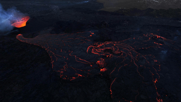 Volcano eruption with snowy mountains in the background
